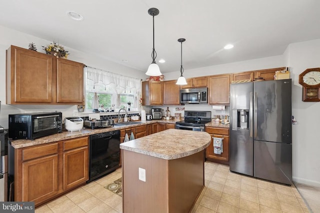 2348 Silver Fox Way, Locust Grove, VA 22508 - kitchen featuring stainless steel appliances, a sink, light countertops, brown cabinetry, and a kitchen island