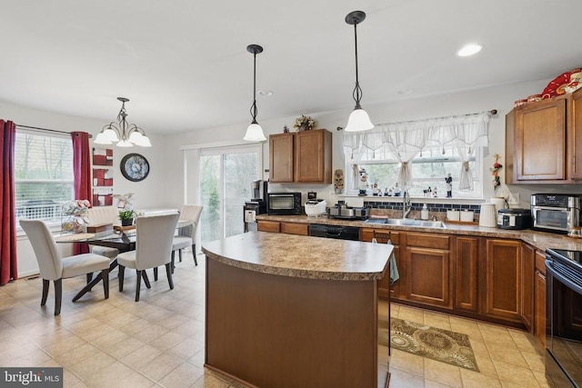 2348 Silver Fox Way, Locust Grove, VA 22508 - kitchen featuring a sink, a center island, brown cabinetry, hanging light fixtures, and recessed lighting