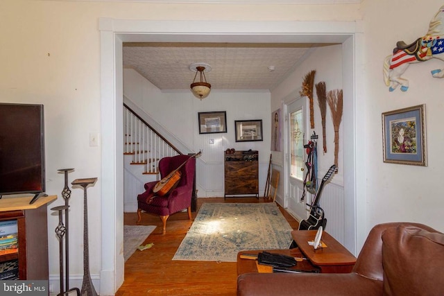 entryway with wood finished floors and stairs
