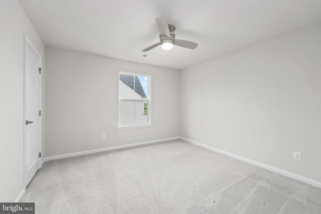 unfurnished room with carpet, baseboards, and ceiling fan