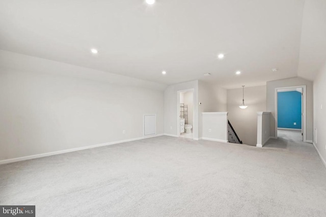unfurnished living room featuring baseboards, recessed lighting, carpet, and vaulted ceiling