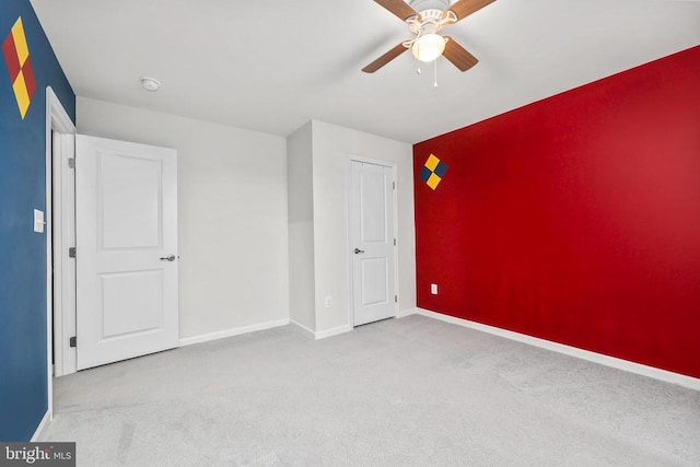 unfurnished bedroom featuring baseboards, ceiling fan, and carpet