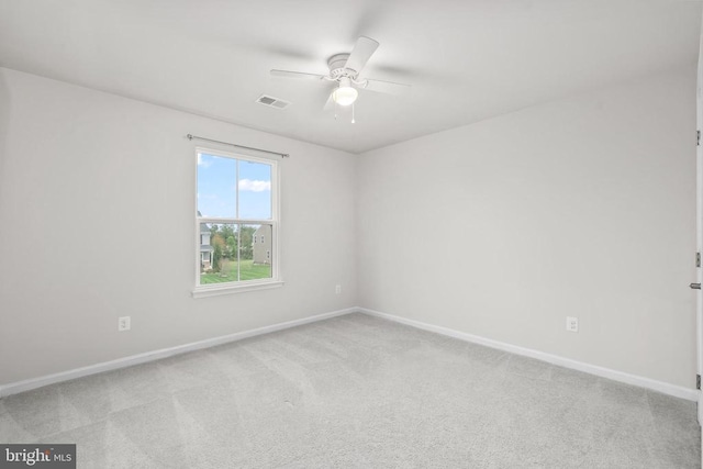 spare room featuring ceiling fan, carpet floors, baseboards, and visible vents