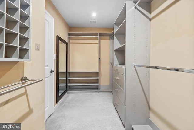 spacious closet featuring visible vents and light colored carpet