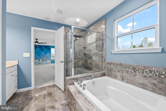 full bath with vanity, visible vents, ceiling fan, a shower stall, and a garden tub