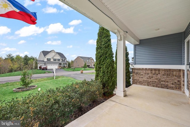 view of patio / terrace with covered porch and a residential view