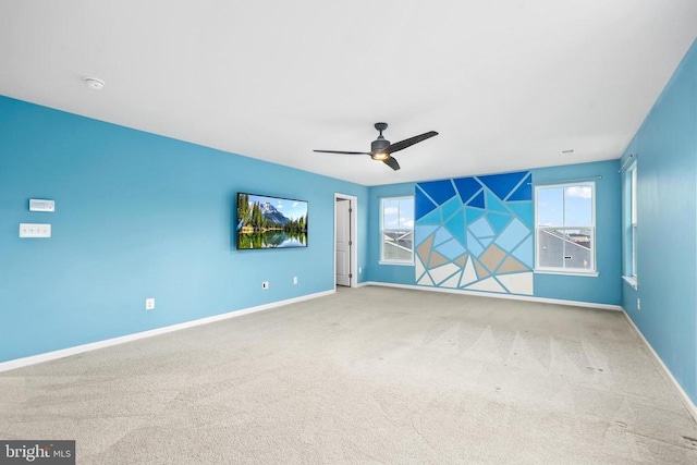 unfurnished room featuring ceiling fan, carpet floors, and baseboards