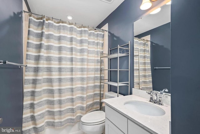 bathroom with vanity, toilet, a shower with curtain, and visible vents