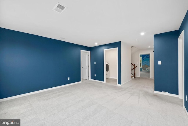 empty room with light colored carpet, visible vents, baseboards, and recessed lighting