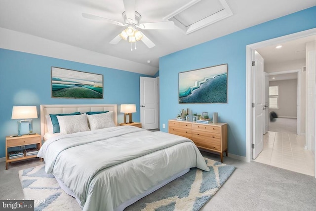 bedroom featuring attic access, light carpet, baseboards, and ceiling fan