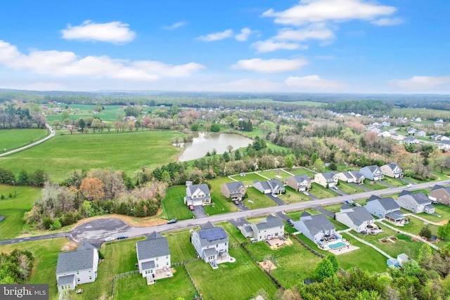 drone / aerial view featuring a water view and a residential view