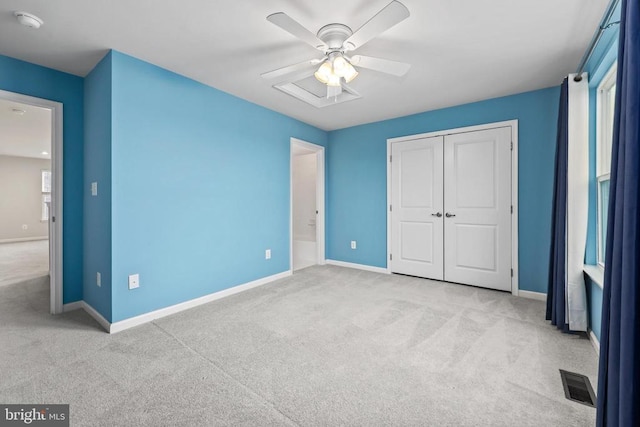 unfurnished bedroom with carpet flooring, a closet, visible vents, and baseboards