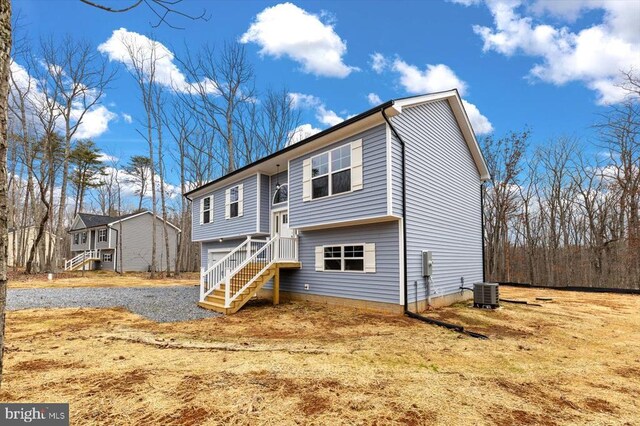 split foyer home with cooling unit and a garage