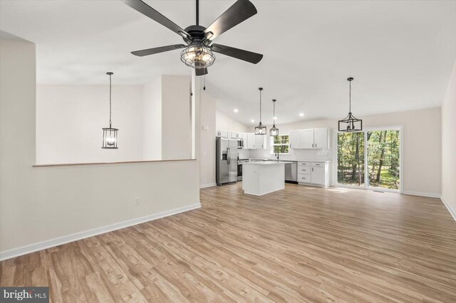 unfurnished living room with lofted ceiling, light hardwood / wood-style flooring, and ceiling fan