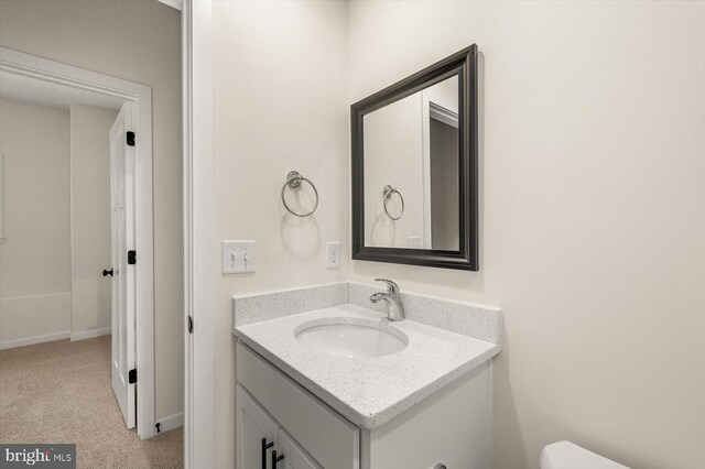 bathroom featuring vanity and toilet