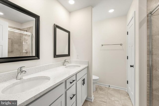 bathroom with walk in shower, tile patterned floors, vanity, and toilet