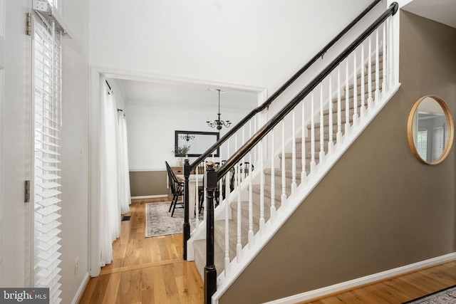 5915 Copper Mountain Dr W, Spotsylvania, VA 22553 - stairway featuring wood finished floors, a chandelier, and ornamental molding