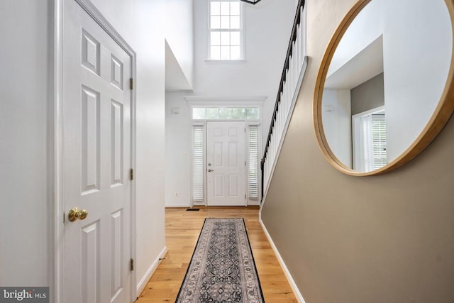 5915 Copper Mountain Dr W, Spotsylvania, VA 22553 - doorway with light wood finished floors, healthy amount of natural light, a towering ceiling, and stairs