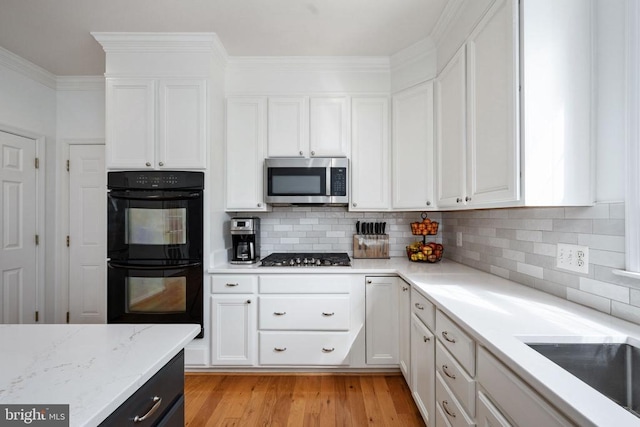 5915 Copper Mountain Dr W, Spotsylvania, VA 22553 - kitchen with stainless steel microwave, white cabinets, and backsplash