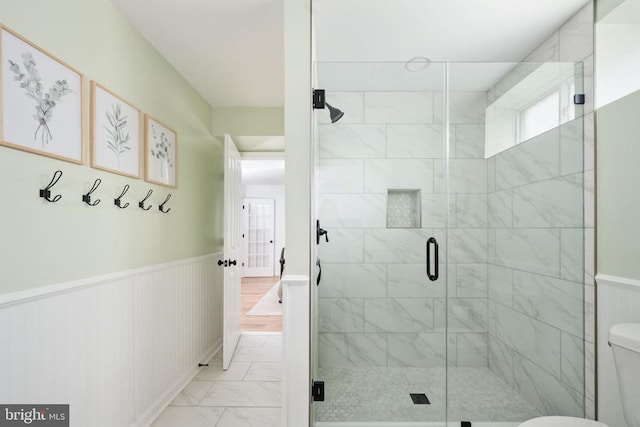 5915 Copper Mountain Dr W, Spotsylvania, VA 22553 - bathroom with marble look tiles, a wainscoted wall, and a shower stall