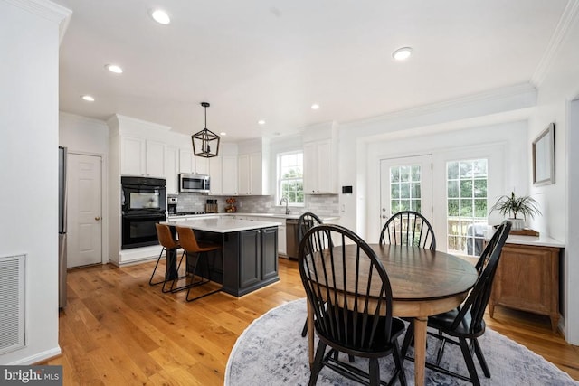 5915 Copper Mountain Dr W, Spotsylvania, VA 22553 - dining room featuring crown molding, plenty of natural light, light wood-style flooring, and recessed lighting