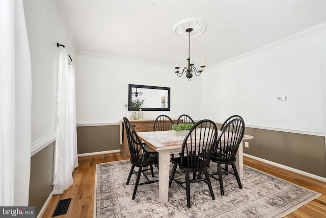 5915 Copper Mountain Dr W, Spotsylvania, VA 22553 - dining room featuring crown molding, a chandelier, and wood finished floors