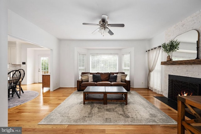 5915 Copper Mountain Dr W, Spotsylvania, VA 22553 - living area with a stone fireplace, a ceiling fan, and light wood-style flooring