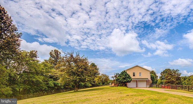 18691 Springs Rd, Jeffersonton, VA 22724 - view of yard featuring an attached garage and concrete driveway