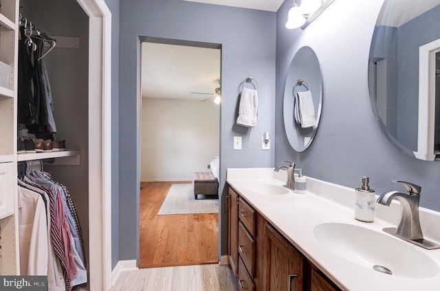 18691 Springs Rd, Jeffersonton, VA 22724 - bathroom featuring wood finished floors, a ceiling fan, double vanity, and a walk in closet