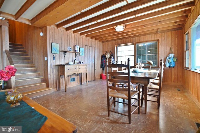 301 Mountain Top Dr, Luray, VA 22835 - dining space with wooden walls, stairs, beam ceiling, and plenty of natural light