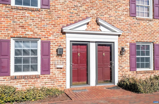 doorway to property with brick siding
