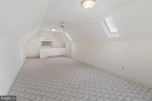 101 Deerwood Rd, Charlottesville, VA 22911 - bonus room featuring a skylight, a wall unit AC, lofted ceiling, baseboard heating, and carpet floors