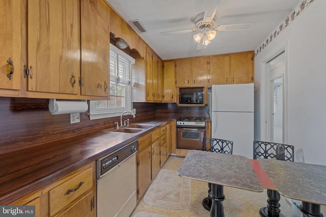 101 Deerwood Rd, Charlottesville, VA 22911 - kitchen with white appliances, dark countertops, ceiling fan, and brown cabinetry