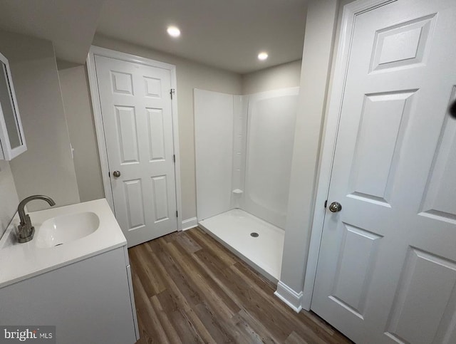  - full bath with vanity, wood finished floors, a shower, and recessed lighting