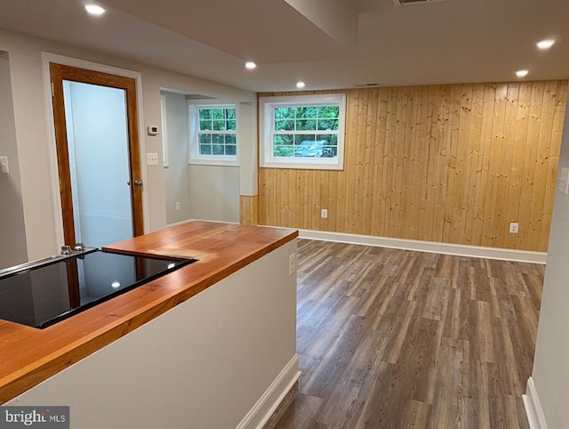  - bar featuring black electric cooktop, wood finished floors, wooden walls, and recessed lighting