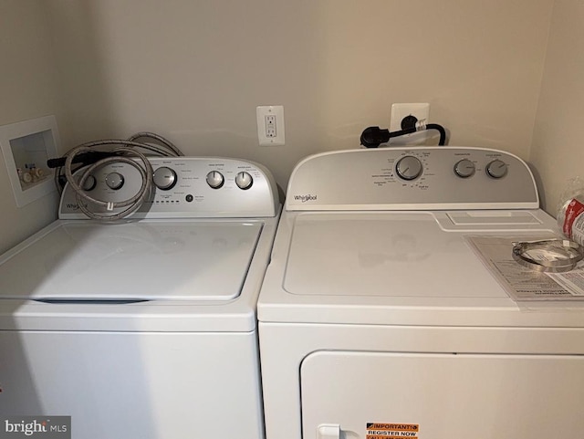  - laundry room featuring washing machine and clothes dryer