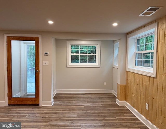 - empty room featuring wood finished floors, recessed lighting, and wood walls