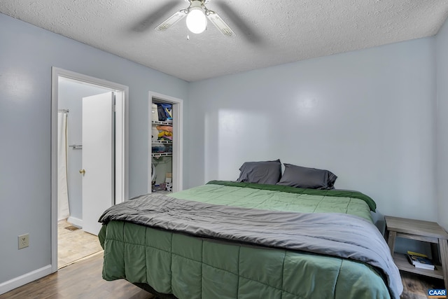 1409 Mica Rd, Mineral, VA 23117 - bedroom featuring wood finished floors, a textured ceiling, ceiling fan, a spacious closet, and ensuite bathroom