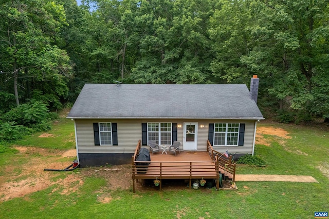 1409 Mica Rd, Mineral, VA 23117 - view of front facade with a front yard, a wooden deck, a chimney, and a forest view