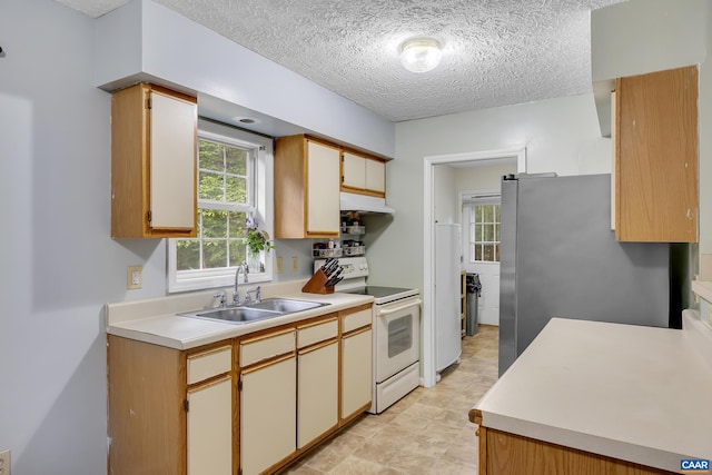 1409 Mica Rd, Mineral, VA 23117 - kitchen with white appliances, a textured ceiling, light countertops, and under cabinet range hood