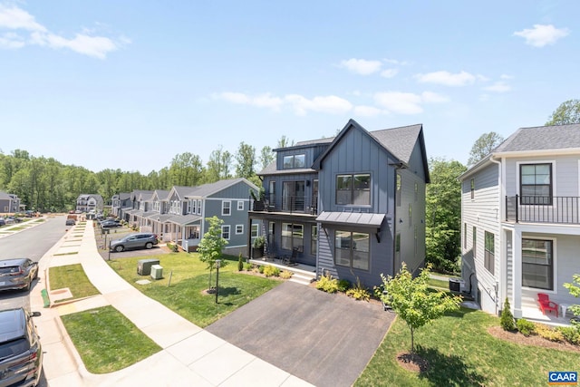 3190 Horizon Rd, Charlottesville, VA 22902 - view of front of property featuring board and batten siding, a front yard, a balcony, and a residential view