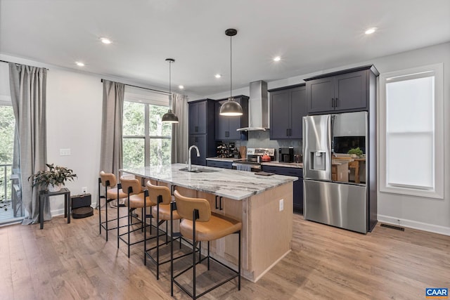 3190 Horizon Rd, Charlottesville, VA 22902 - kitchen featuring appliances with stainless steel finishes, wall chimney range hood, a sink, a center island with sink, and light stone counters
