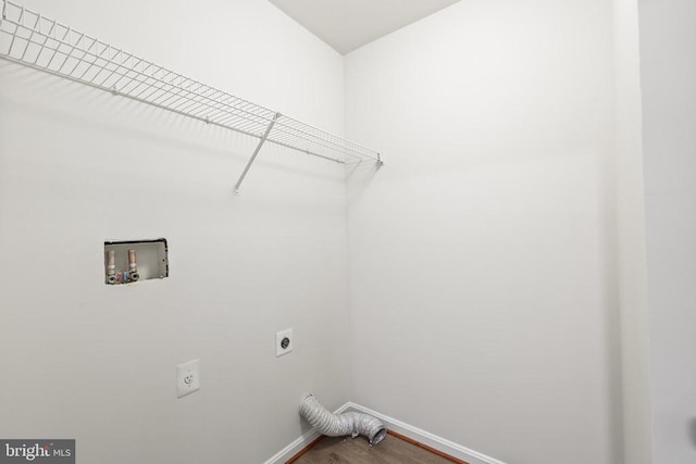 washroom featuring electric dryer hookup, baseboards, hookup for a washing machine, and wood finished floors
