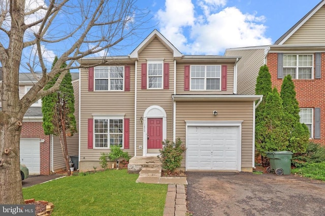 view of front of house with a garage, driveway, and a front yard