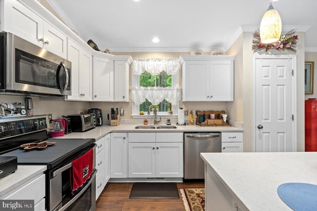 7401 Stubbs Bridge Rd, Spotsylvania, VA 22551 - kitchen with stainless steel appliances, a sink, white cabinets, light countertops, and ornamental molding