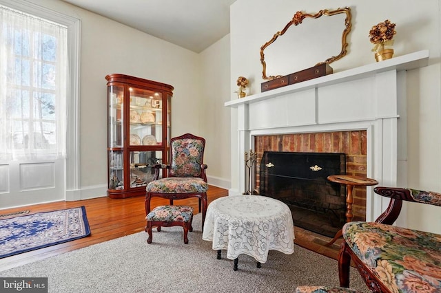 133 Fairview Rd W, Culpeper, VA 22701 - sitting room featuring baseboards, a brick fireplace, wood finished floors, and visible vents