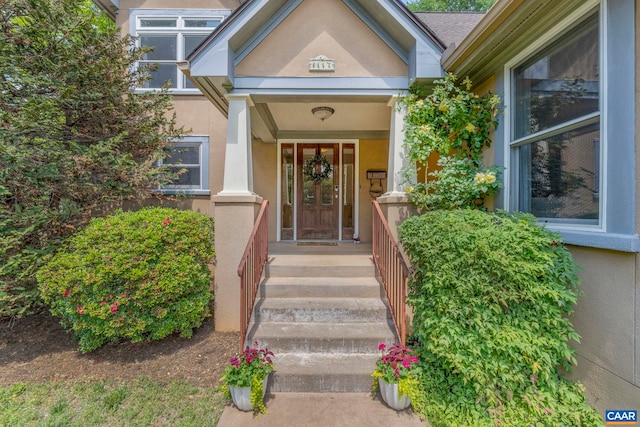 doorway to property featuring stucco siding