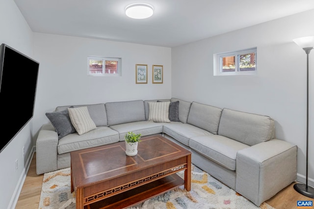 living room featuring light wood-type flooring and baseboards