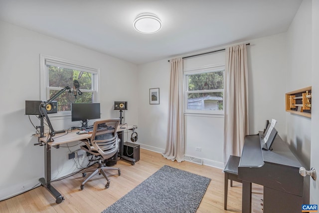 office with light wood-style floors and baseboards
