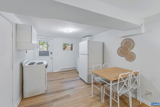 kitchen featuring white appliances, a baseboard heating unit, light wood-style floors, and white cabinetry